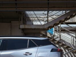 a silver car parked in front of a set of stairs