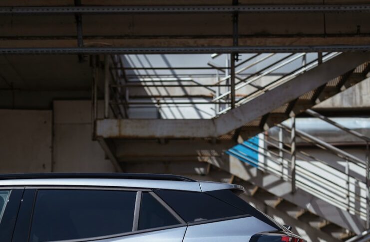 a silver car parked in front of a set of stairs